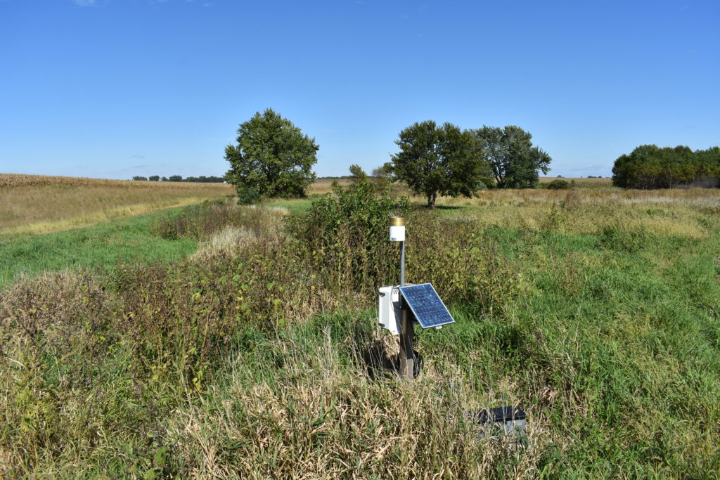 A solar-powered data logger measures water levels at an experimental saturated riparian buffer. It was installed by a team from Iowa State, whose research determined criteria that show more farmland qualifies to safely install riparian buffer strips. Credit: Loulou Dickey