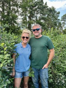 Amy Wysocki and her brother Eric standing together with trees in the background.