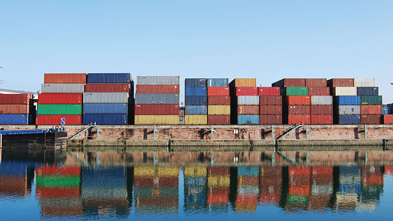 Cargo container in a harbor with water reflections