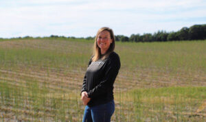 Farmer Mary Sheppard standing in a field.