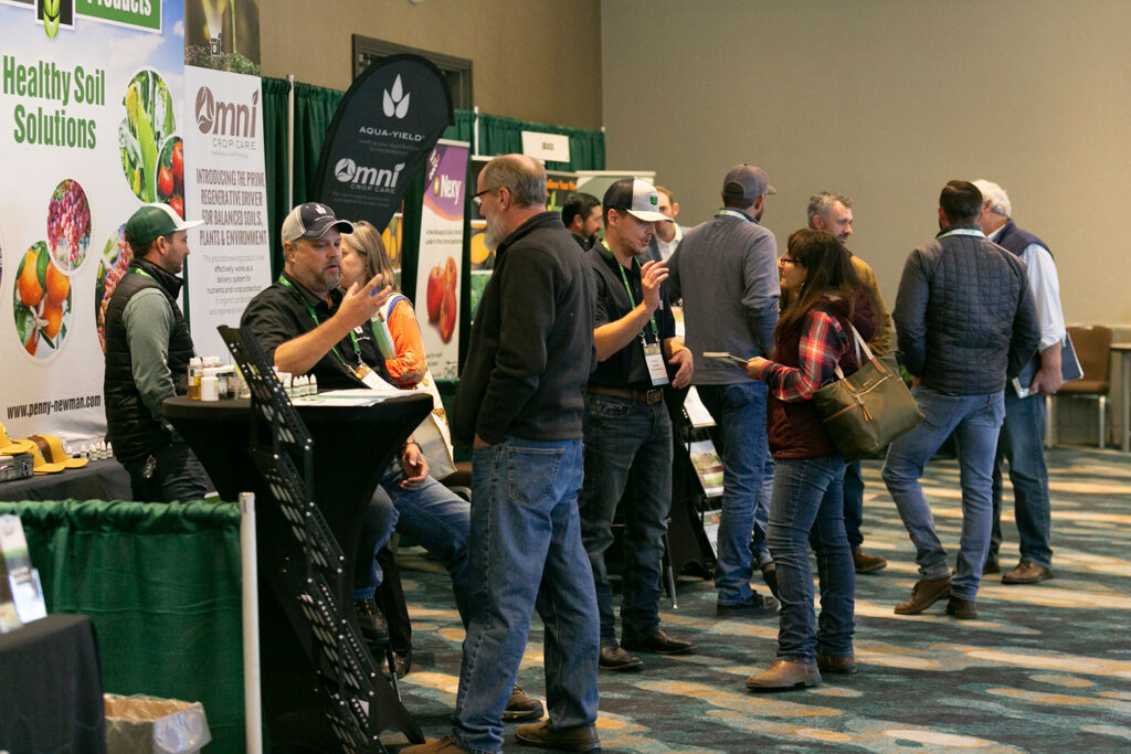 OGS attendees speaking with members of Penny Newman and Decco on the trade show floor
