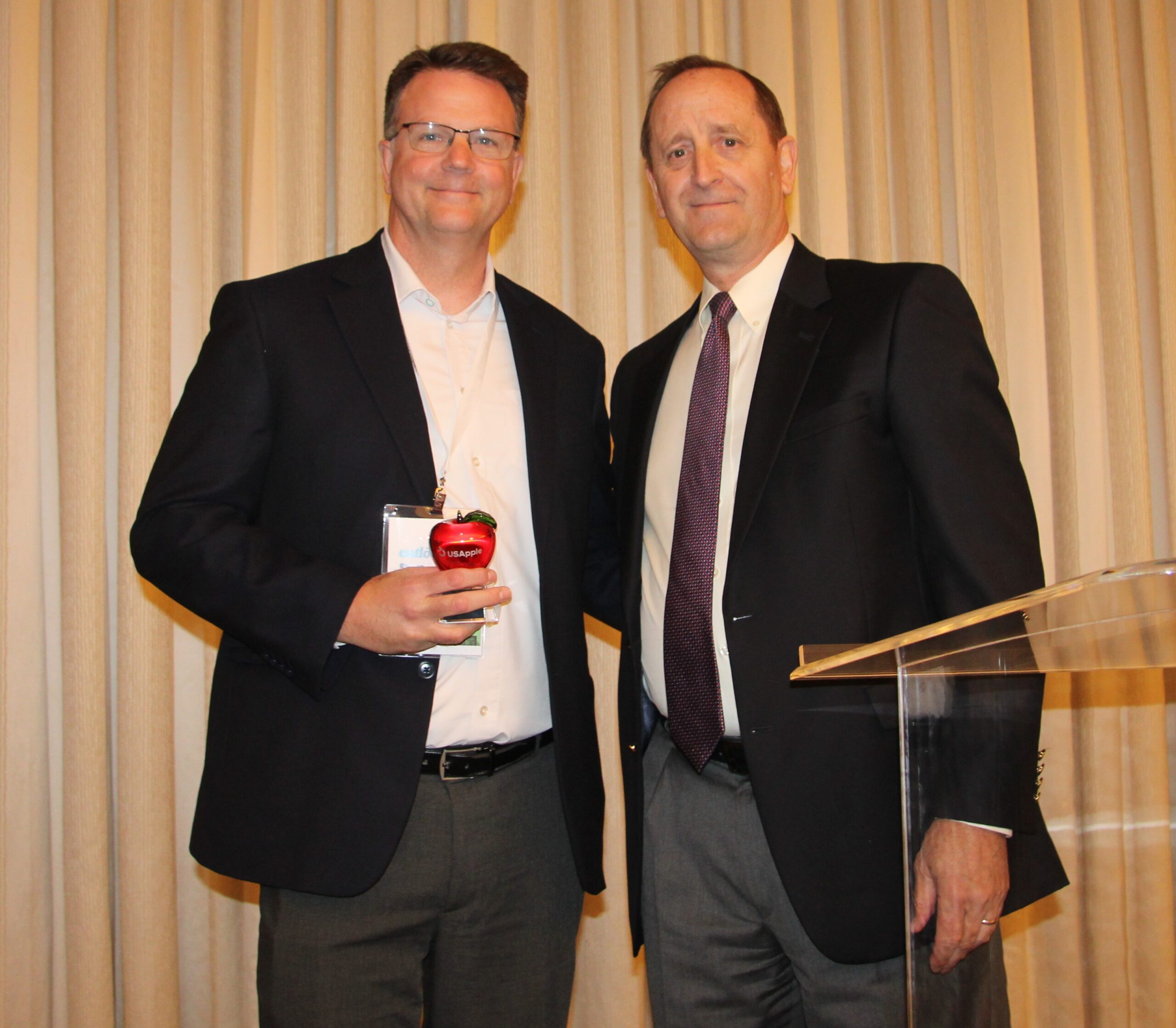 Photo of Steve Clement receiving Apple Champion Award from USApple’s Jim Bair.
